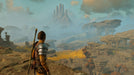 Gameplay screenshot - Atreus gazes over a vast rocky landscape with towering peaks in God of War Ragnarök on PS5. Embark on a mythological journey—purchase your CD Key US at RushGame.co