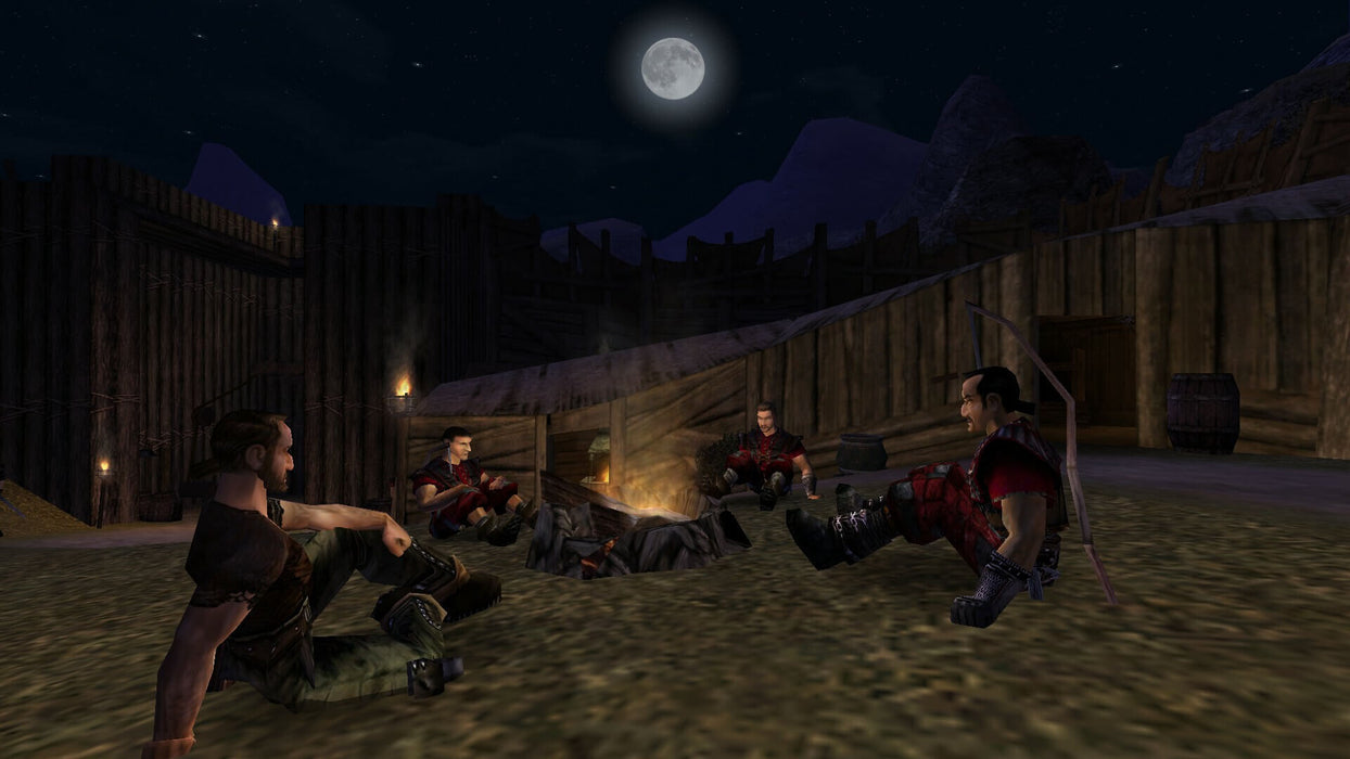 Gameplay screenshot - In-game screenshot from Gothic Universe Edition on PC, showing a group of mercenaries sitting around a campfire in a medieval encampment under the moonlight. Experience this classic RPG with a Steam CD Key from RushGame.co