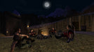 Gameplay screenshot - In-game screenshot from Gothic Universe Edition on PC, showing a group of mercenaries sitting around a campfire in a medieval encampment under the moonlight. Experience this classic RPG with a Steam CD Key from RushGame.co