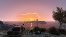 Gameplay screenshot - A player in Grand Theft Auto V for Xbox One sits on the hood of a classic car, gazing at a breathtaking ocean sunset. Experience the beauty of Los Santos and expand your empire with the GTA V Premium Online Edition CD Key from RushGame.co