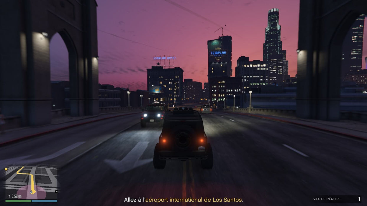 Gameplay screenshot - Nighttime gameplay in Grand Theft Auto V on Xbox One, showcasing a high-speed chase through the streets of Los Santos with neon-lit skyscrapers in the background. Get your GTA V Premium Online Edition key at RushGame.co