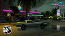 Gameplay screenshot - Grand Theft Auto: Vice City gameplay on PC Steam, featuring a classic sports car parked outside a neon-lit car wash on a rainy night. Purchase your GTA Vice City digital key at RushGame.co for fast activation
