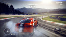 In-game screenshot from GRID 2 on PC Steam, showcasing a red sports car performing a high-speed drift on a professional circuit with mountains in the distance. Master precision racing—get your GRID 2 CD key today at RushGame.co