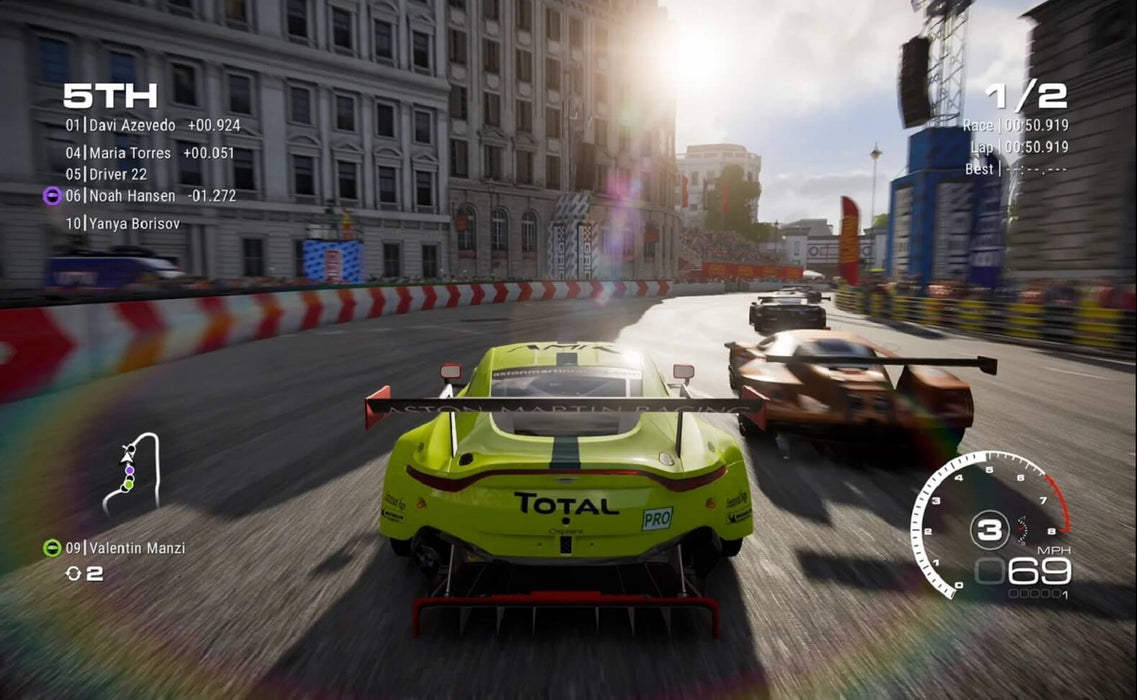 Gameplay screenshot - A thrilling city race in GRID Legends, with a bright yellow Aston Martin battling for position in a crowded circuit. Buy GRID Legends Xbox key instantly at RushGame.co