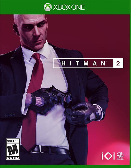 Official cover art of HITMAN 2 for Xbox One, showing Agent 47 adjusting his suit while holding a pistol, dressed in his iconic black suit and red tie against a deep red background. Step into a world of stealth and strategy—get your Xbox One CD key instantly at RushGame.co