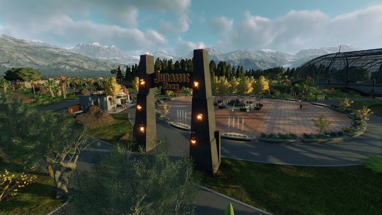 In-game screenshot from Jurassic World Evolution 2 on Xbox, showcasing the iconic Jurassic Park entrance surrounded by beautiful scenery. Get your Xbox One or Series X|S digital key for Jurassic World Evolution 2 (EU) at RushGame.co