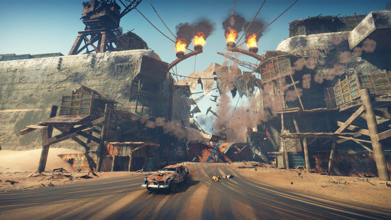 Explosive action in Mad Max PC Steam Key as Max speeds through a crumbling gate with flames and debris flying. Get the best price on Mad Max Steam Key at RushGame.co