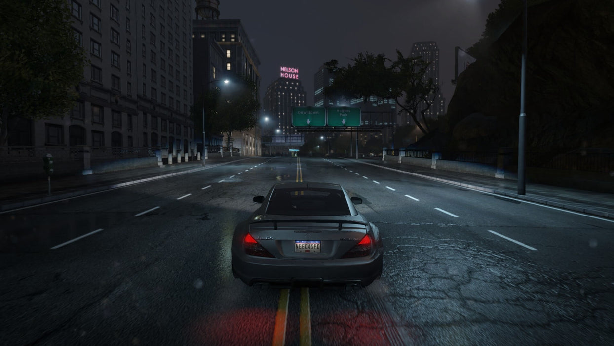 A nighttime street scene in Need for Speed: Most Wanted, with a black sports car cruising through a dimly lit urban area. Feel the intensity of street racing under the cover of darkness. Get your game key now at RushGame.co