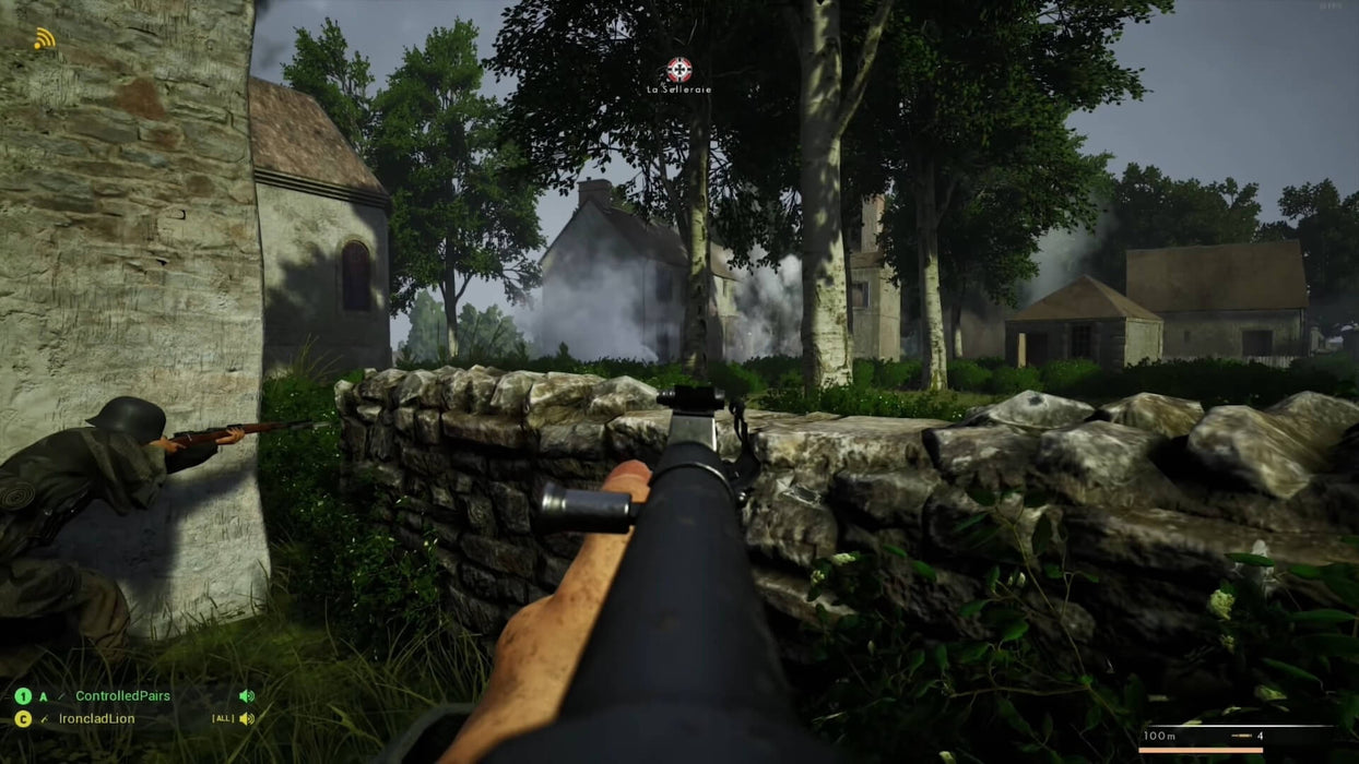 In-game screenshot from Post Scriptum on PC Steam, showing a soldier aiming his rifle behind a stone wall in a forested European village—get your WW2 tactical shooter Steam key at RushGame.co