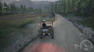 Gameplay screenshot from Ranch Simulator (PC Steam) showing a player driving a utility vehicle down a dirt road through the forest — build your dream ranch with a Steam key from RushGame.co