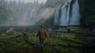 Player explores a misty forest area with a powerful waterfall in Red Dead Redemption 2. Enhance your adventure with the Rockstar Social CD Key from RushGame.co