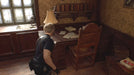 Leon Kennedy investigates a rustic writing desk in a dimly lit room, searching for clues in Resident Evil 4 (2023). Get your digital Xbox CD Key now at RushGame.co and relive the survival horror classic in a stunning remake