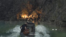 Leon S. Kennedy pilots a small motorboat through a stormy cave toward a torch-lit cavern in Resident Evil 4 (2023). Buy the Xbox Series X|S CD Key for Resident Evil 4 AR at RushGame.co and uncover the dark secrets of the lake.