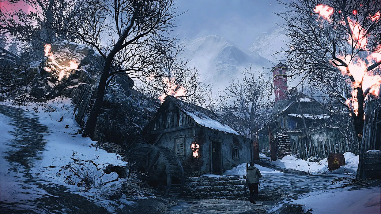 A burning village shack set against snowy mountains in Resident Evil Village Gold Edition, featured in the PC Steam game key bundle on RushGame.co.