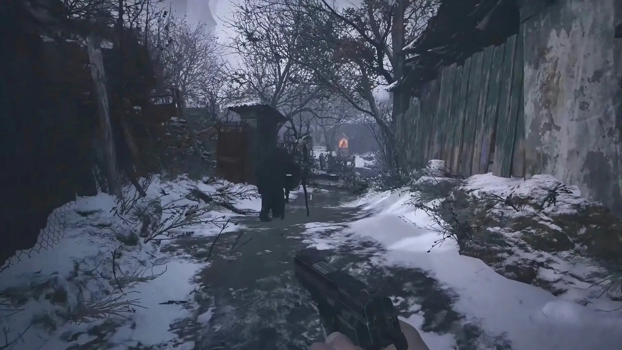 In-game screenshot from Resident Evil Village on PC Steam showing a snowy path and eerie figure ahead, enhancing the chilling atmosphere of the survival horror experience. Buy your digital game key at RushGame.co for instant delivery