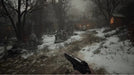 In-game screenshot from Resident Evil Village showing a snowy graveyard path and pistol in hand. Buy Resident Evil Village Xbox Series X|S CD Key now at RushGame.co for instant digital delivery