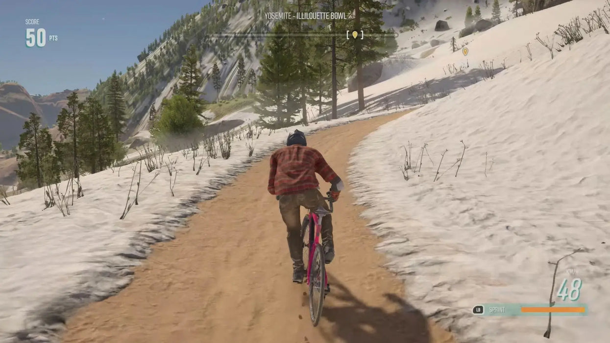 Mountain biking gameplay in Riders Republic Year 1 Pass DLC, player cycling uphill on a scenic, snow-covered Yosemite trail. Secure your Xbox activation key today at RushGame.co