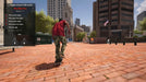 In-game screenshot from Session Skate Sim on Steam, featuring a skater in a red shirt riding through a brick plaza during the Ollie tutorial. Purchase your Session Skate Sim Steam Key at RushGame.co for instant delivery and start your digital skateboarding adventure today.