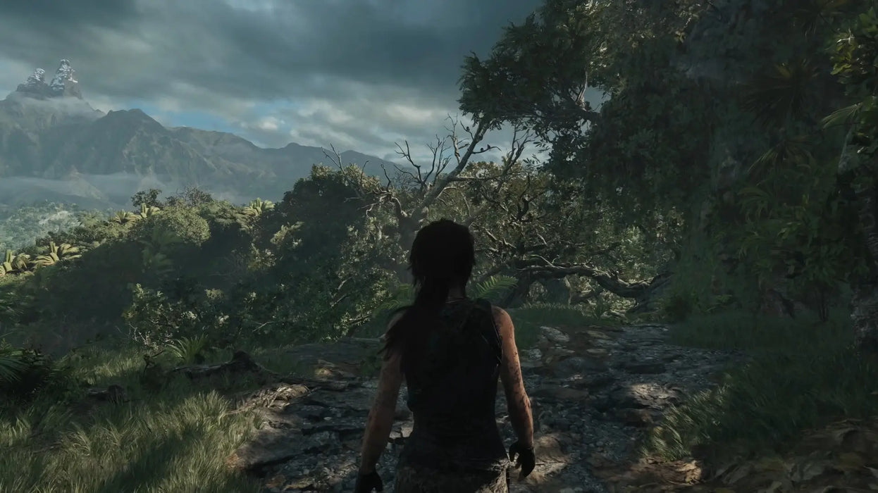 Scenic in-game view from Shadow of the Tomb Raider Definitive Edition, featuring Lara Croft overlooking a vast, mountainous jungle. Purchase your digital Steam code at RushGame.co and join the legendary journey today